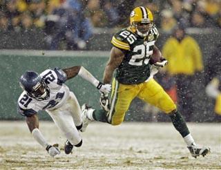 Seattle Seahawks running back Shaun Alexander (37) is tacked by Green Bay  Packers safety Atari Bigby (20) for a 1-yard loss during the first quarter  of the NFC Divisional Playoff at Lambeau