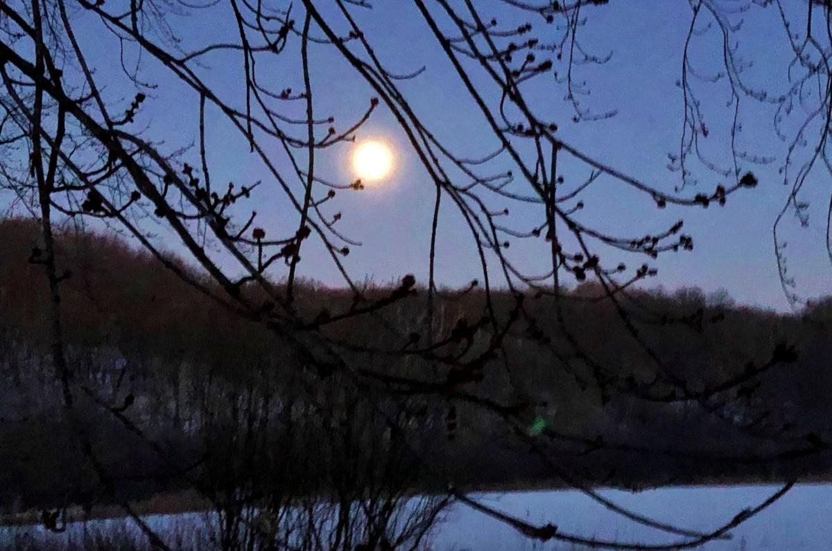Full moon rises over lake