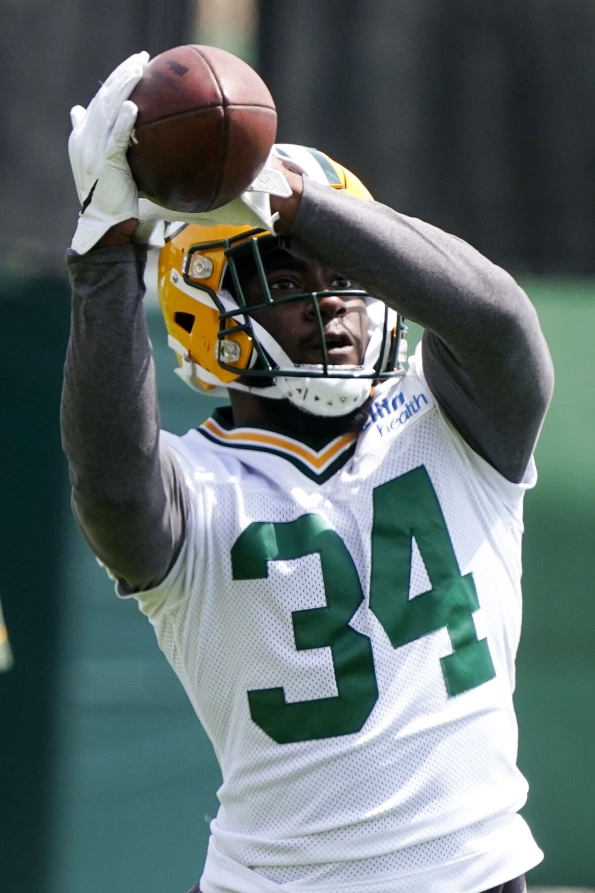 Green Bay Packers' T.J. Slaton runs a drill at the NFL football