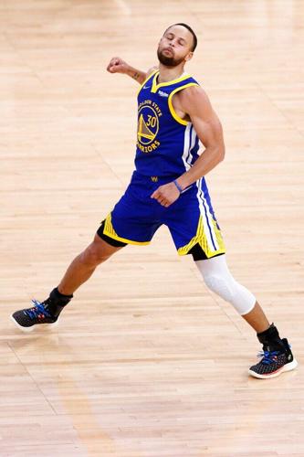 Former Davidson College player Stephen Curry watches other