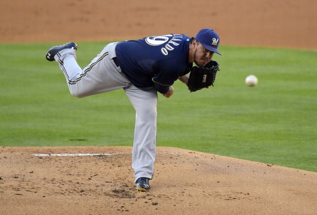 Milwaukee Brewers starting pitcher CC Sabathia catches a ball