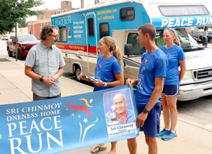 Runners from across the world share message of peace during stops in Winona, La Crosse