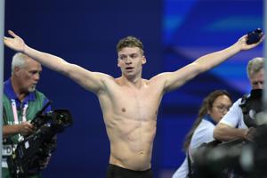 Léon Marchand captures 4th Olympic swimming gold, setting off a party across Paris
