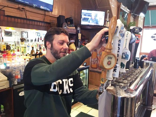 Ryan Benkendorf pours a beer from new tappers at John's Main Event