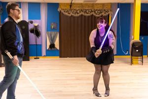 He teaches lightsaber classes, she teaches burlesque fitness. And they're in love