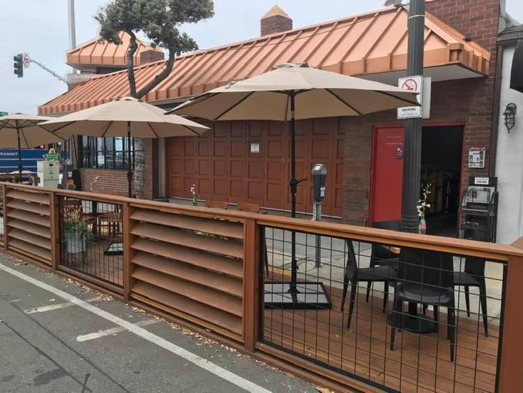 Downtown Laguna newsstand wraps after losing parking to dining parklet