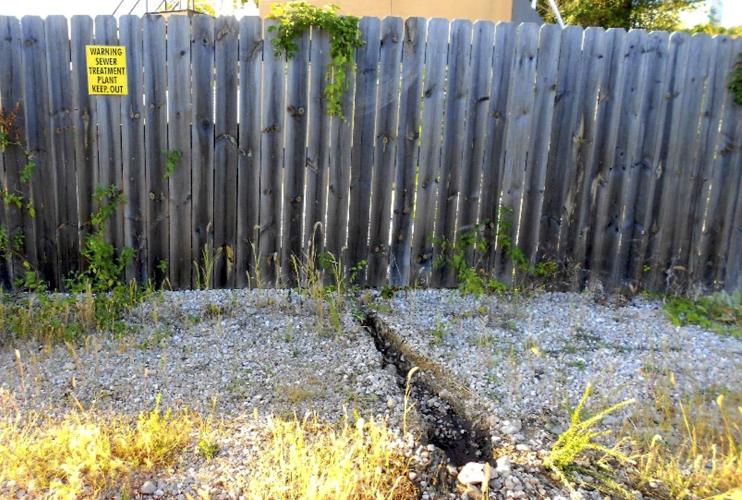Trench From Rapidly Flowing Sewage Under The Fence
