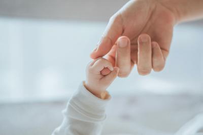 Baby's Hand Holding Mother or Father's Finger