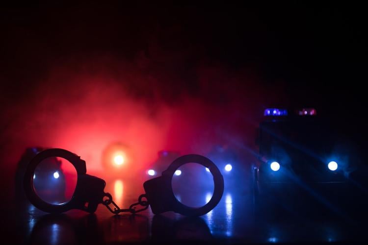 Handcuffs and Police Car Lights