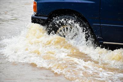 Car in flooded road - stock