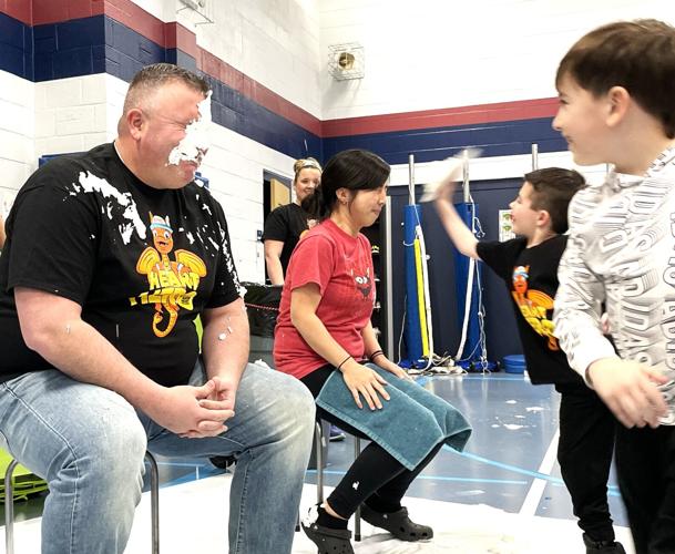 Brookwood Schools District Administrator Drew Halbesma and Digital Expansion Director Helen Xiong take whipped cream pies in the face
