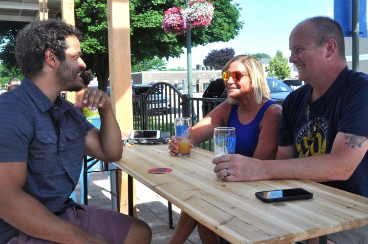 Eli Hinton, left, visits the Topsy Turvy Brewery with friends Jill Rasmussen and Dave Rasmussen