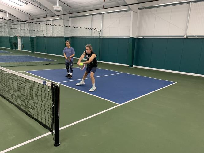 Residents play a game of pickleball in the new pickleball facility