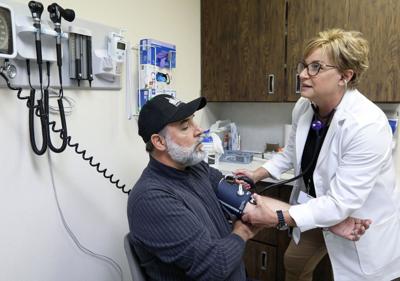 Tina taking Mario's blood pressure (copy)