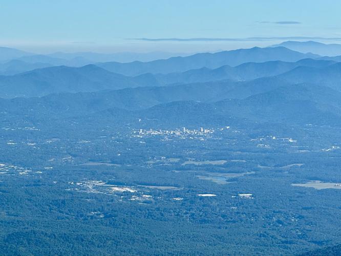 Asheville, seen here from 12 miles to the southwest, is surrounded by lush woodlands that power the region's tourism economy.