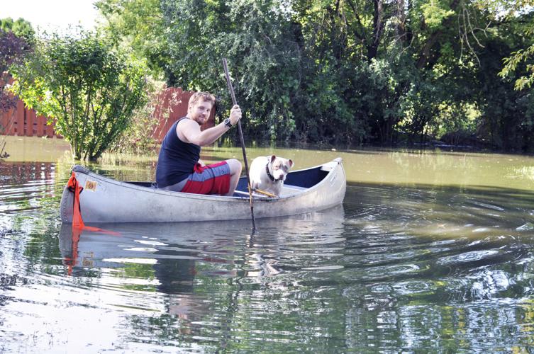 Dillan Schneider man in canoe flood