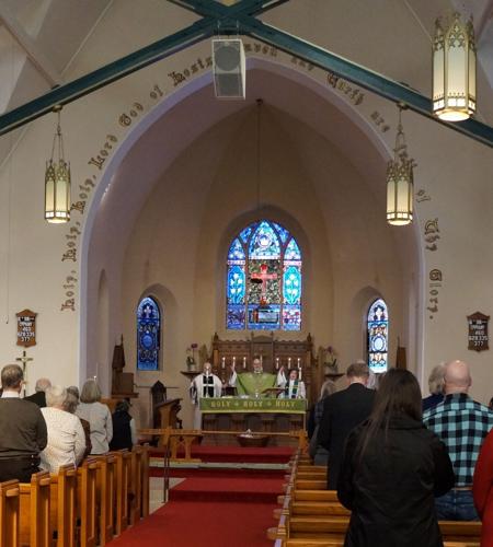 The Rt. Rev. Jeffrey D. Lee celebrates the eucharistic rite during his visitation at Episcopal Church of the Holy Communion, Lake Geneva