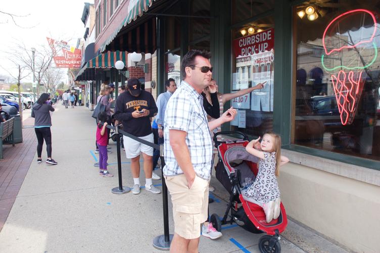 Customers wait in line at Kilwins candy shop