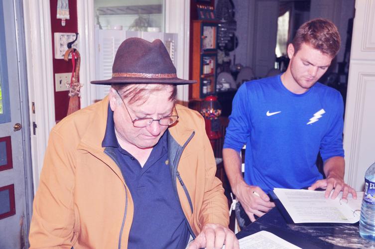 Harold Johnson, left, and Nick Robison study their lines during a rehearsal session