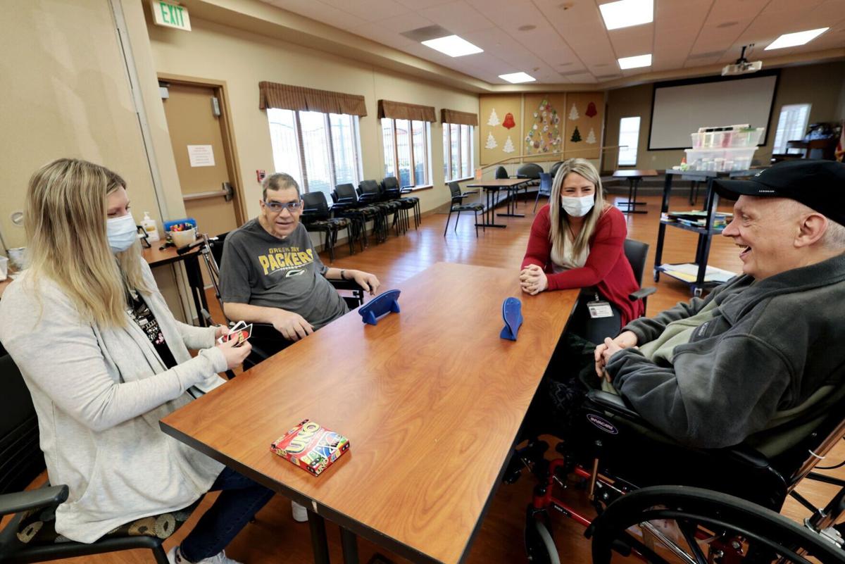 Residents and therapists playing Uno