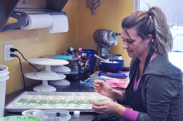 Abby Miller, Lorelei Bittner's Bakery employee, decorates some cookies