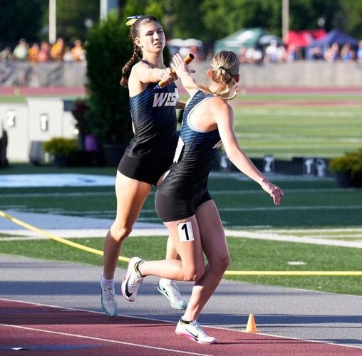 New Berlin West High School sophomore Raquel Gerovac passes the relay track baton to senior Aubrey Lane in the Division 2 girls 4x400 meter relay final during the WIAA State Track and Field meet in La Crosse, Wisconsin on Saturday, June 6, 2026.