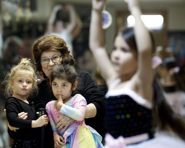 Betty Hayes-Baxter holding students in preschool class