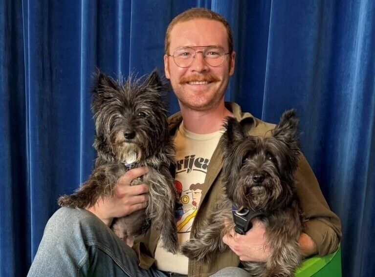 Landon Boyle poses with dogs Nessa and Alfie