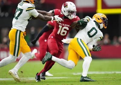 Arizona Cardinals cornerback Max Melton (16) breaks away from a block by Green Bay Packers receiver Romeo Doubs (87) to tackle Matthew Golden (0) at State Farm Stadium in Glendale on Oct. 19, 2025.