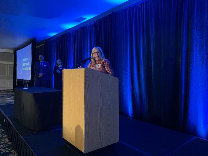 Beth Tumas, owner of The Bottle Shop, accepts the Hospitality Award