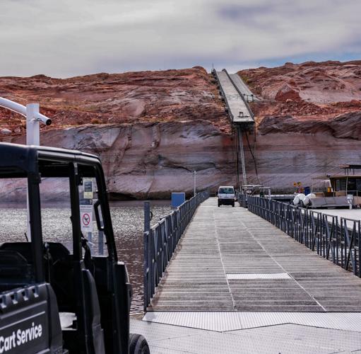 Low water levels in Lake Powell are apparent in this February 2026 image showing the end of a floating dock hanging off a cliff at Antelope Marina in Page, Arizona. Workers carved a new path to the water through the solid rock.