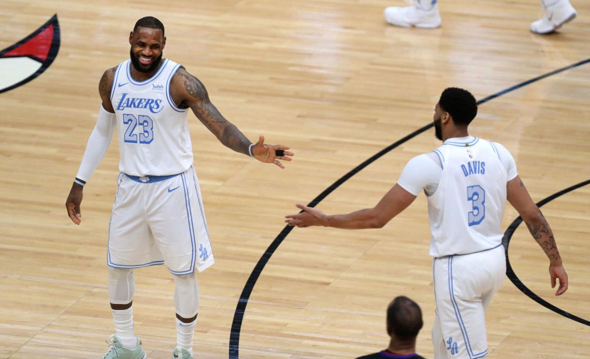 Los Angeles Lakers forwards LeBron James and Anthony Davis celebrate in the second half against the Chicago Bulls at the United Center in Chicago on Saturday, January 23, 2021.