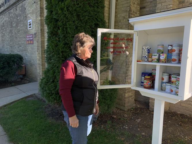 Terri Smith looks through one of the blessing boxes at Lake Geneva United Methodist Church