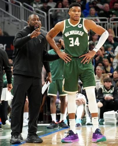 Milwaukee Bucks coach Adrian Griffin talks with forward Giannis Antetokounmpo during a November 2023 game.