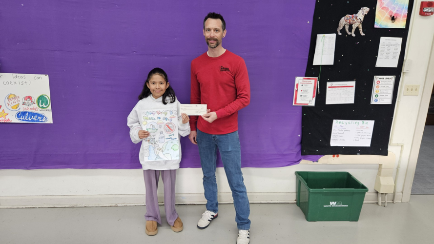 Fontana Elementary School student Ximena Perez receives $100 check for taking first place in water conservation poster contest