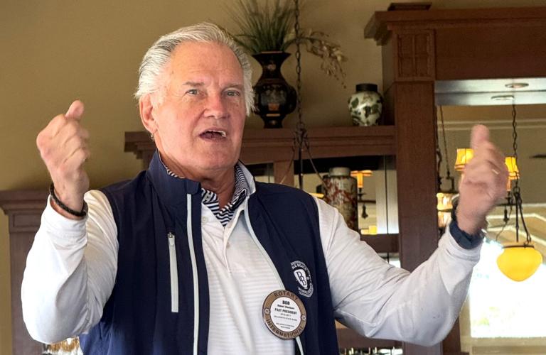 Rotarian and 2010-2011 President Robert Klockars leads singing at the Geneva Lake West Rotary Club's 75th anniversary luncheon