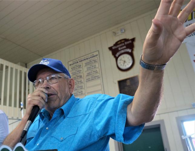 Auctioneer Gary Finley presides over the 2022 Walworth County Fair Meat Animal Auction at the Wiswell Center