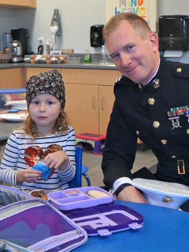United States Marine Corps veteran Capt. Chris Potsch enjoys a Veterans Day lunch with his daughter Lily