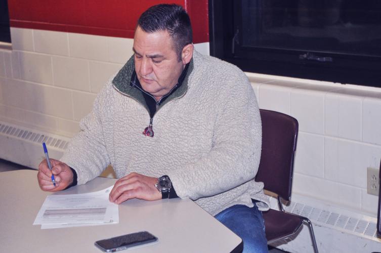 Dimitri Anagnos, co-owner of Popeye's on Lake Geneva, completes a survey regarding