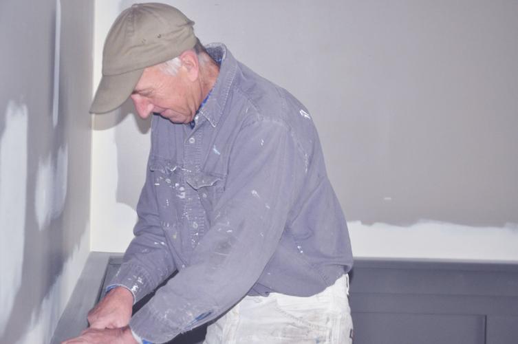 Cal Johnson, owner of Cal Johnson Decorating, prepares to do some interior work at the future location