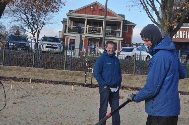 Paul Malinka, Ice Castle employee, does some digging work on Riviera Beach