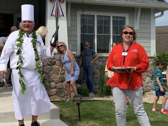 Christi Hunter, VISIT Lake Geneva partner manager, presents a plaque to Chef John Bogan for being a member for 32 years