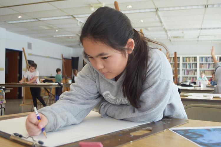 Agnes  Cairns, 10, works on drawing her wildlife image at Wustum museum