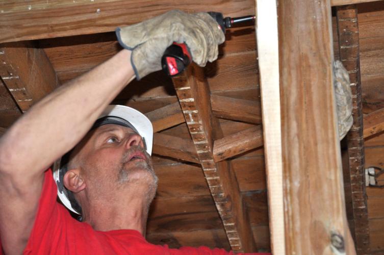 Edward Holzman of the Nikao Group does some renovation work to the Brick & Mortar building