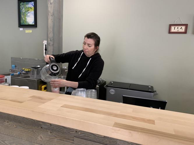 Emely Peterson makes a tea drink at High Point Nutrition