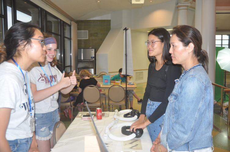 Rachel Lee and Sydney Scerea, both left, talk to Kyung Lee and Diane Lee, Rachel's mother and sister,