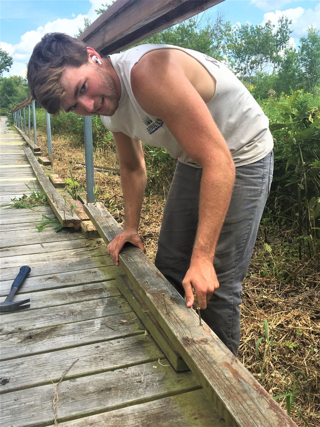 Kishwauketoe summer intern Joel Myers performs boardwalk repairs