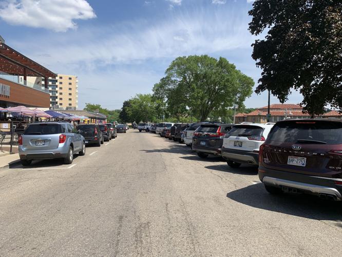 Many vehicles are parked along Wrigley Drive during a weekday afternoon