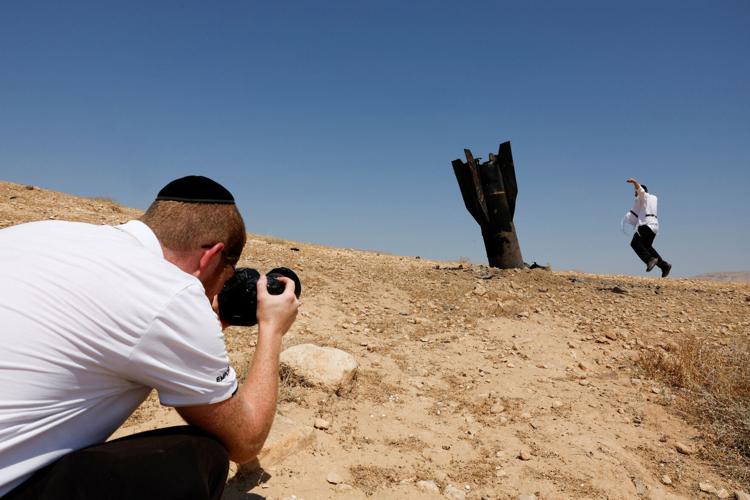 Part of a missile protrudes from the ground, following strikes from Iran, in the central Israeli-occupied West Bank