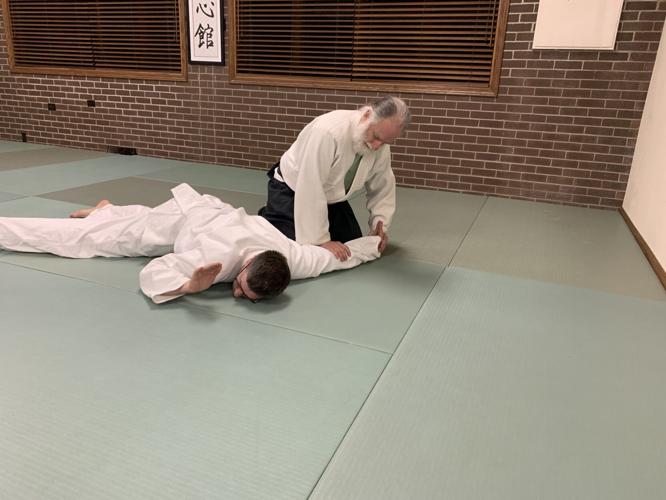 Students Bruce Kyes and Seth Klosinski practice some aikido techniques